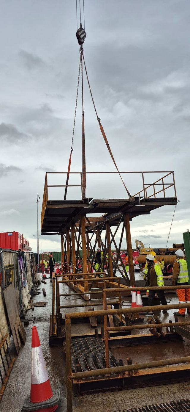 Fabricated steel platform being lifted by crane