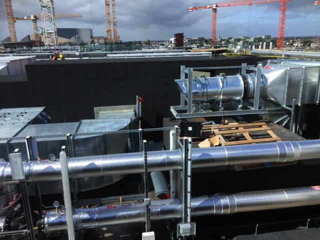 Insulated pipework runs on a rooftop plant area
