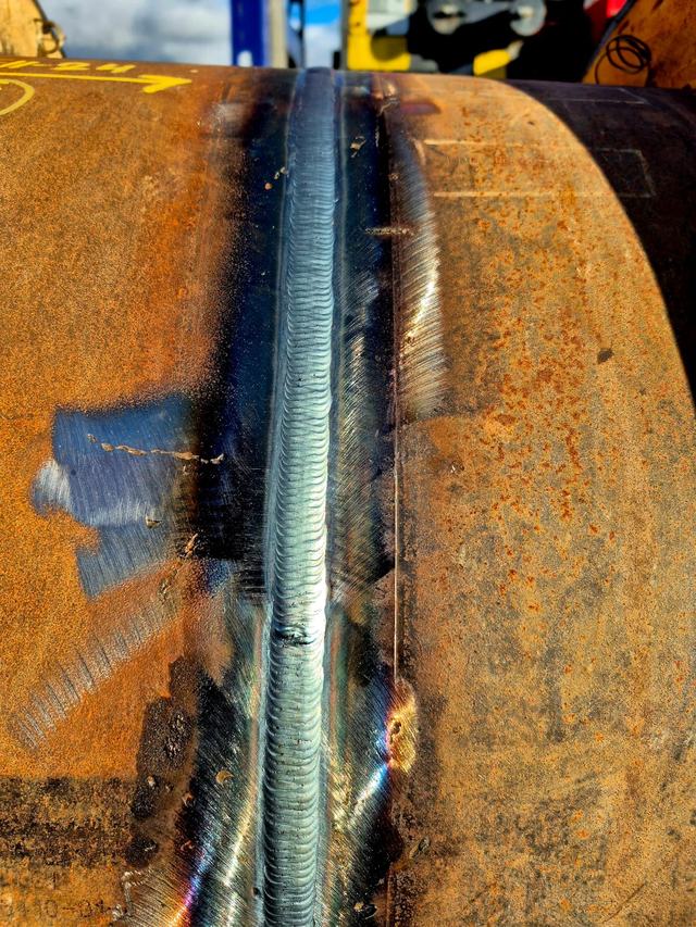 Close-up of a welded seam on a steel pipe