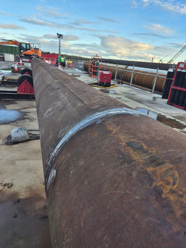Large steel pipe laid out on site